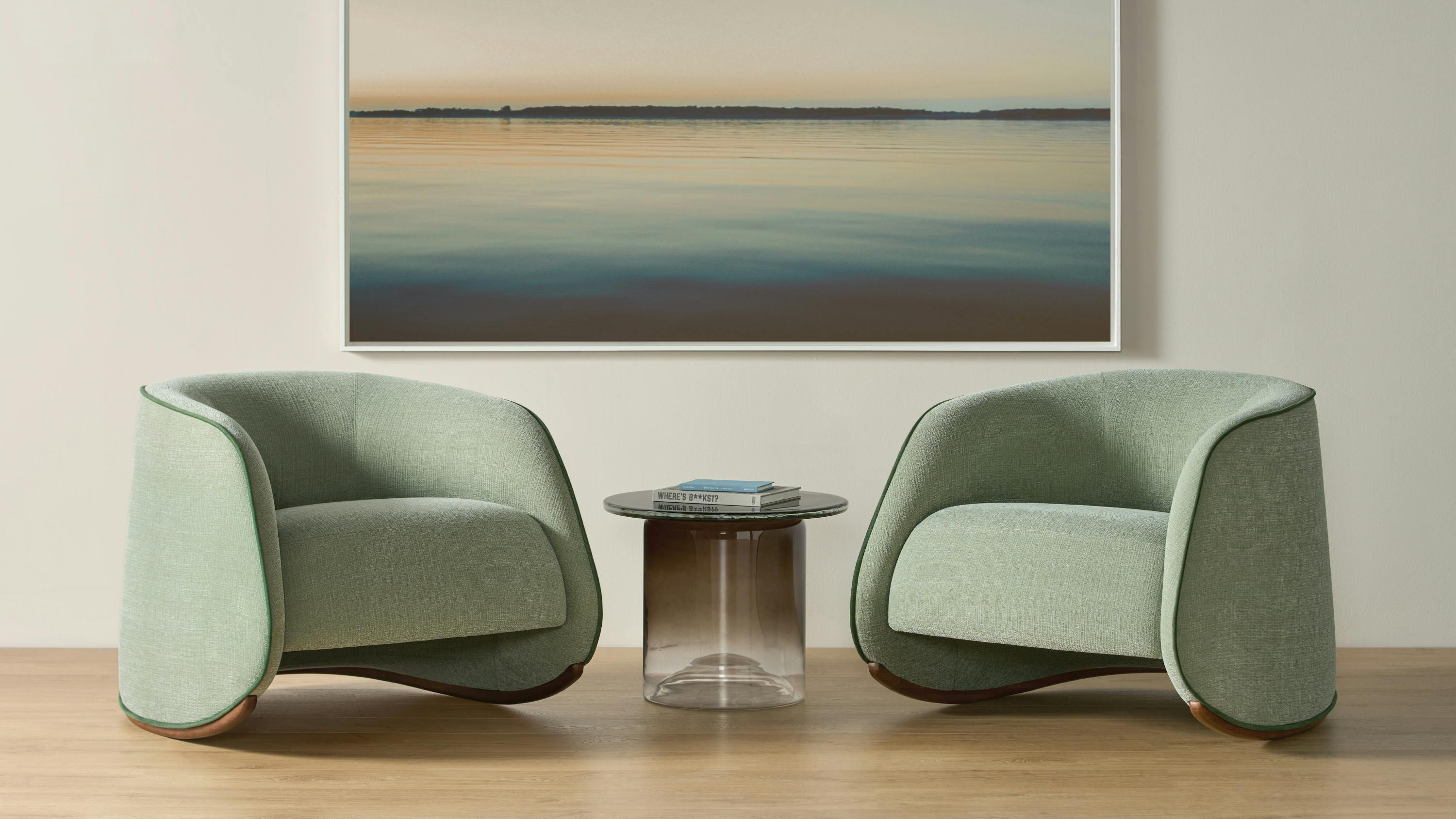 The Abra rocking chair features a curved shape balanced on a solid oak base.