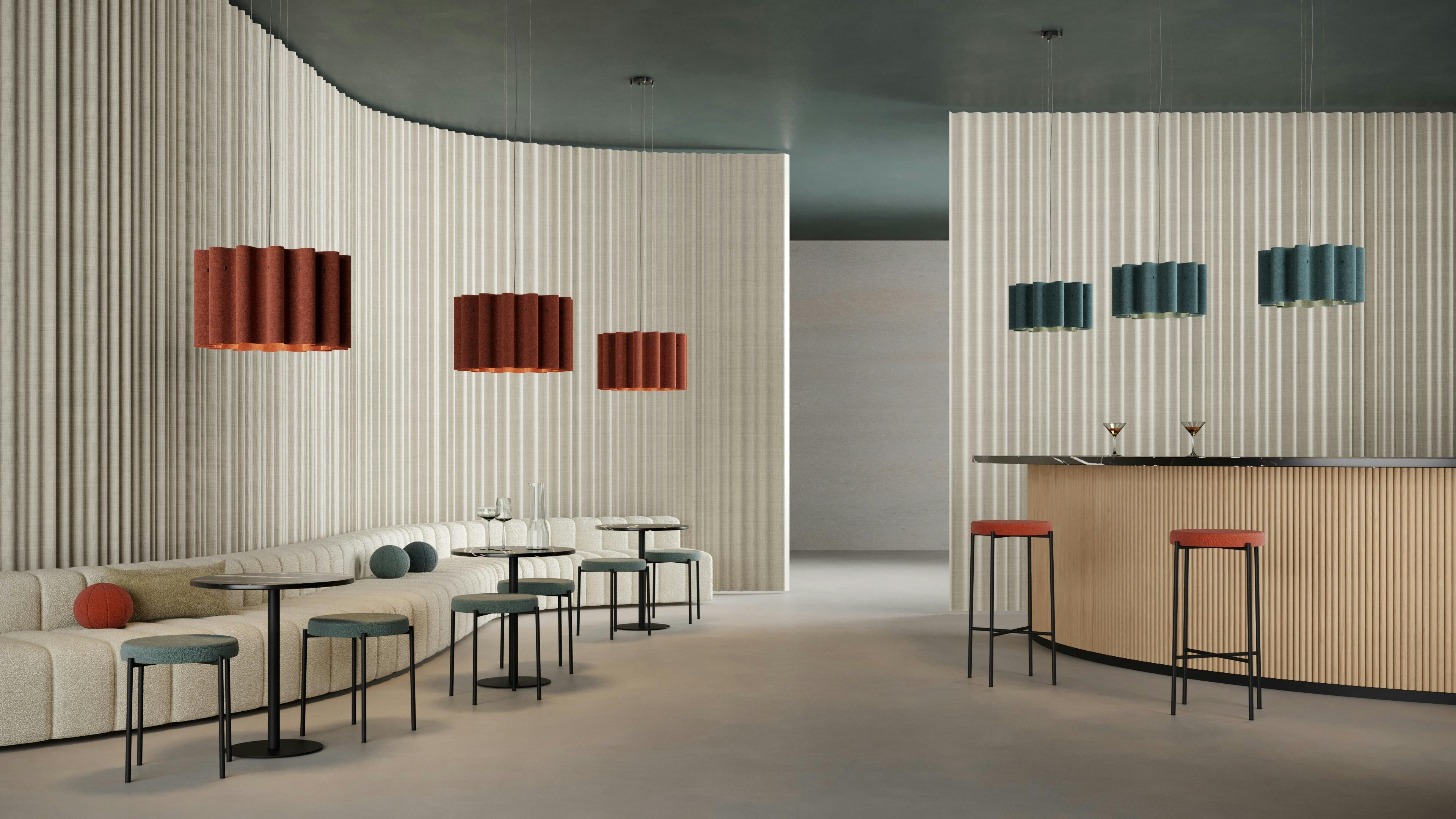 Luxxbox's Kurtain acoustic pendant suspended over a bar and lounge seating.
