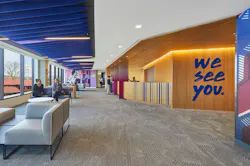 Bright, daylit lobby with lounge seating, wood-paneled walls and a large, blue 'we see you' graphic. Bright, daylit lobby with lounge seating, wood-paneled walls and a large, blue 'we see you' graphic.