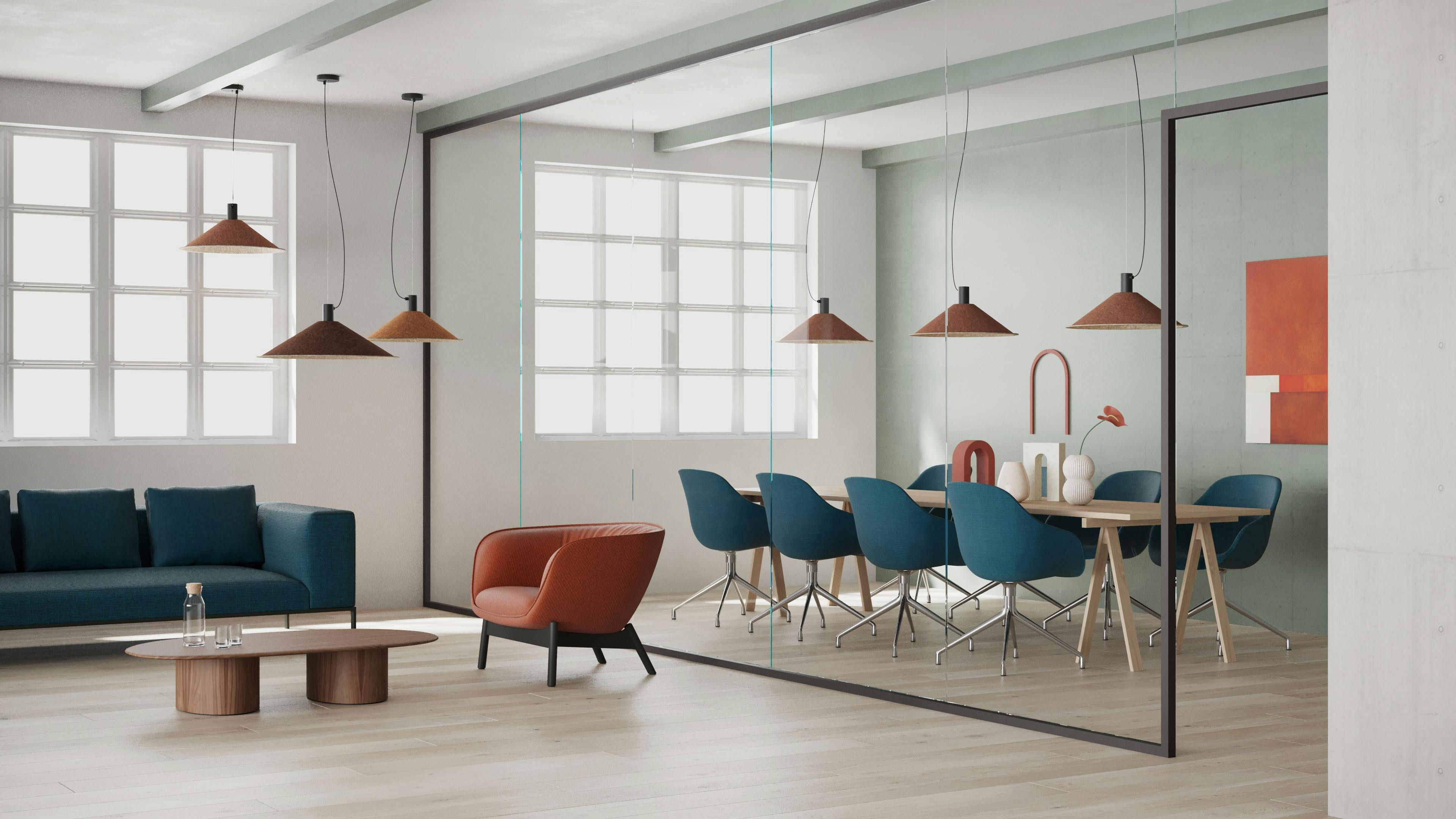 The Sierra Acoustic Pendant is suspended from the ceiling above a dining table and gathering area.