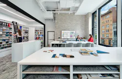 The finish library features shelving hanging from a structural beam and set up onto a beam to support the weight of the shelves on the wrap floor. The finish library features shelving hanging from a structural beam and set up onto a beam to support the weight of the shelves on the wrap floor.