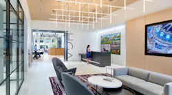 The entrance to HGA's office features a waiting area and a reception desk. The company name is displayed on the wall leading into the office space. The entrance to HGA's office features a waiting area and a reception desk. The company name is displayed on the wall leading into the office space.