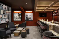 Rust-red walls in the lounge make a rich background for art inspired by the region, while curved barstools bring to mind a modern take on tribal patterns in a similar red-earth tone. Rust-red walls in the lounge make a rich background for art inspired by the region, while curved barstools bring to mind a modern take on tribal patterns in a similar red-earth tone.