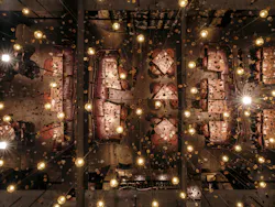 View looking toward the ceiling: The chandelier installation symbolizes how food and iron are forged in flame. View looking toward the ceiling: The chandelier installation symbolizes how food and iron are forged in flame.