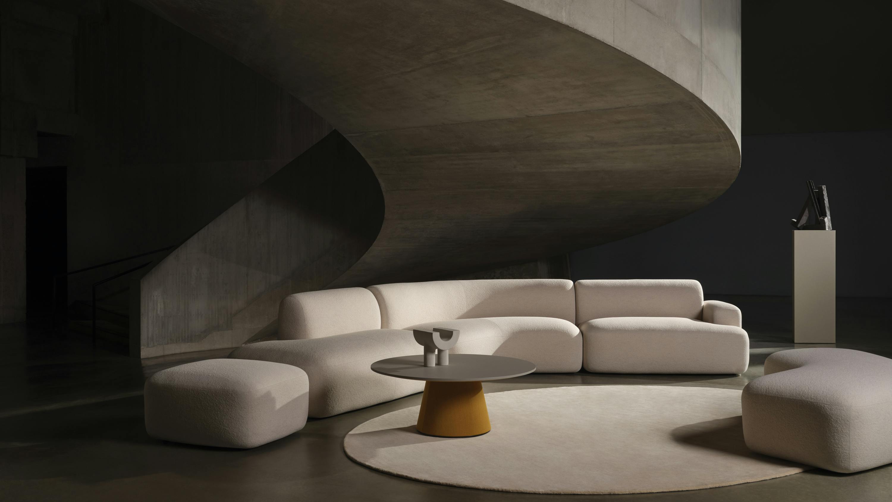 Beau Modular Lounge System from Boss Design set in a living room with a rug and coffee table.