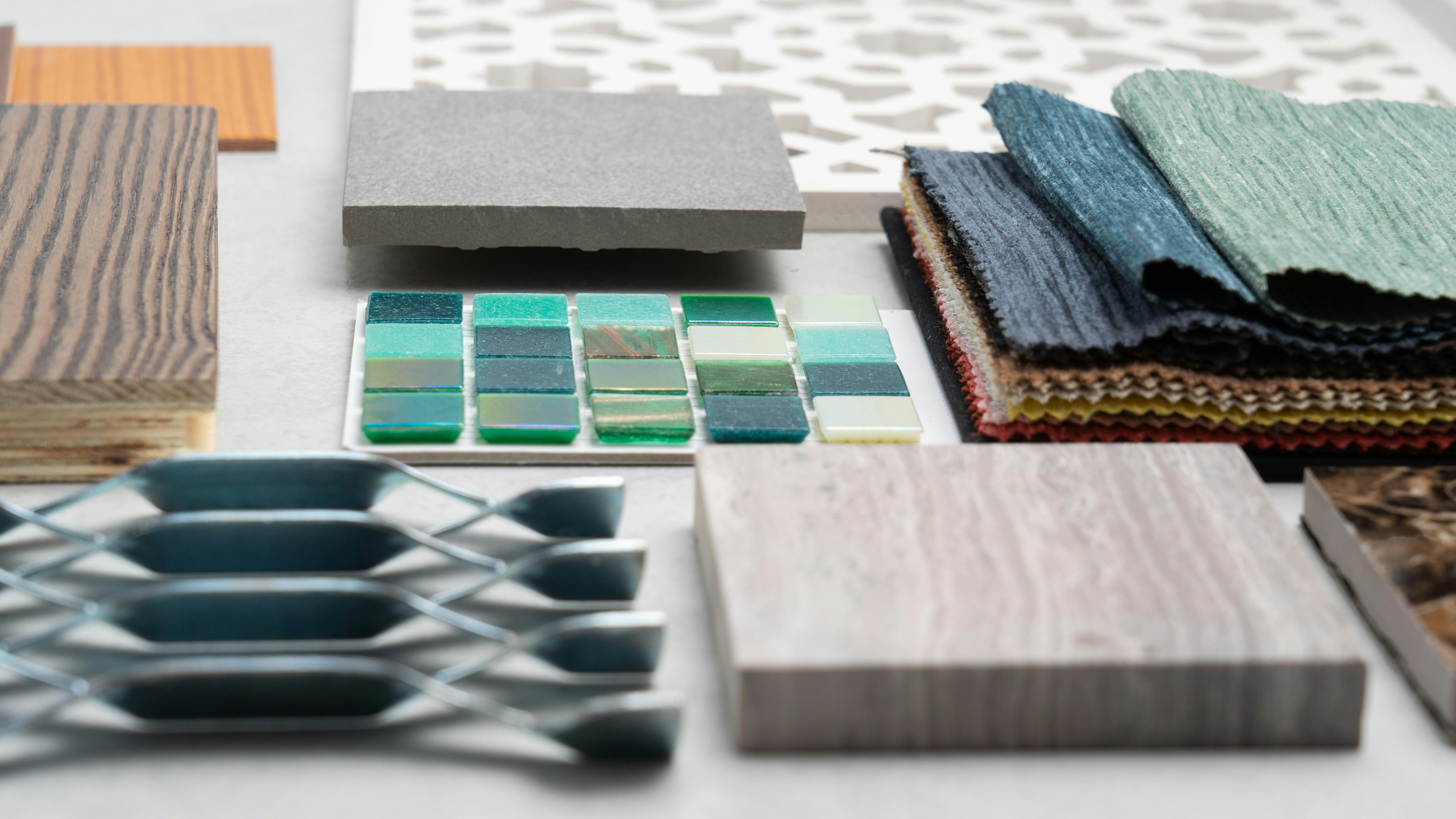 Close-up of various product samples including tiles, fabrics and wood veneers.