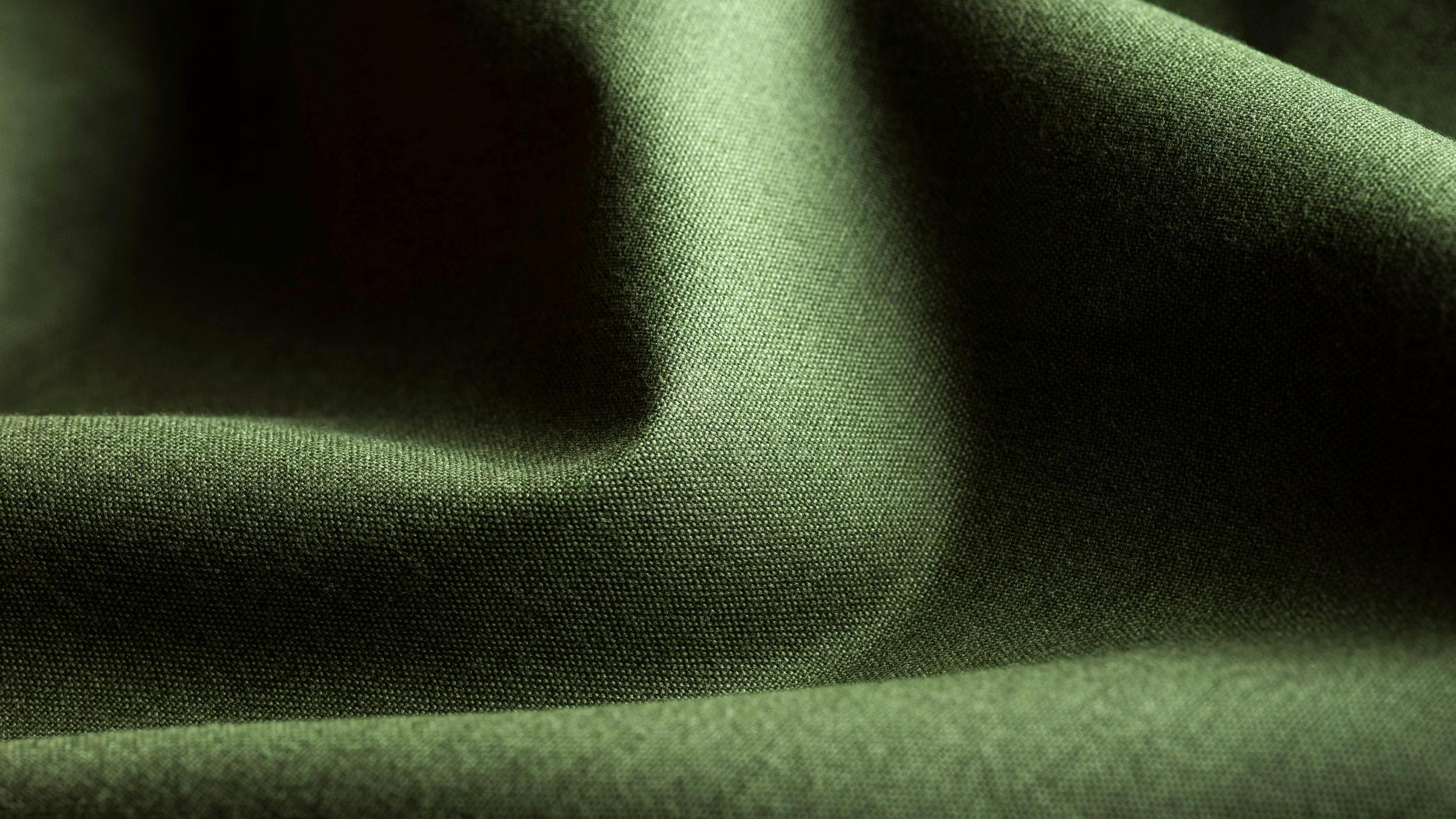 Close-up view of bio-based Spinnova textile in green.