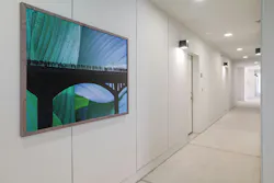 View of corridor with large blue and green artwork on wall. View of corridor with large blue and green artwork on wall.