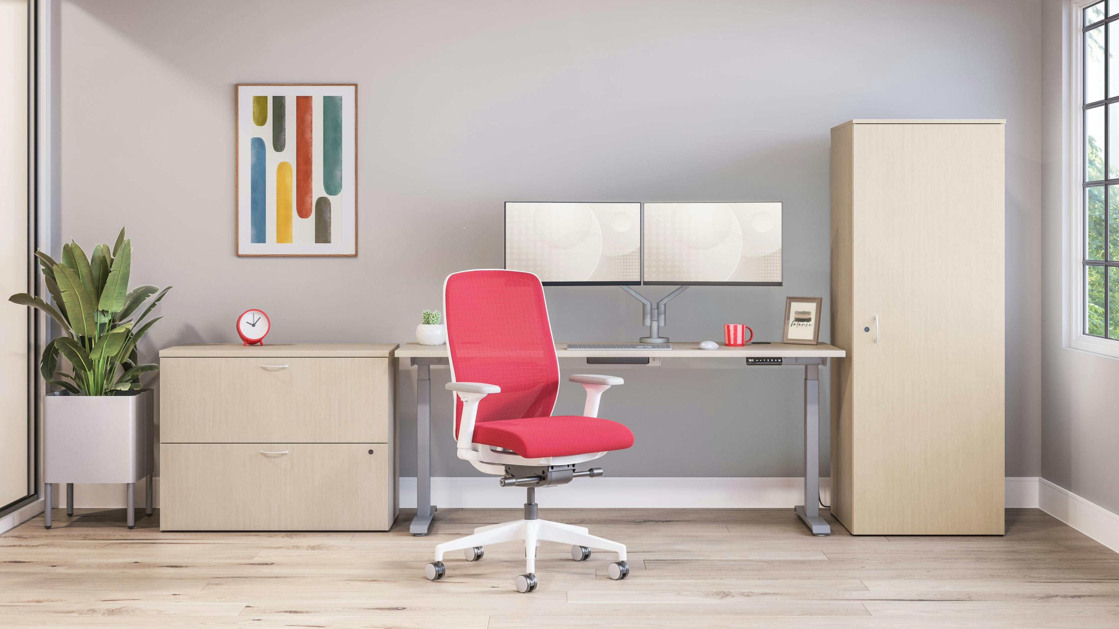 Modern task chair in red upholstery fabric in an office setting with light wood floors and furniture.
