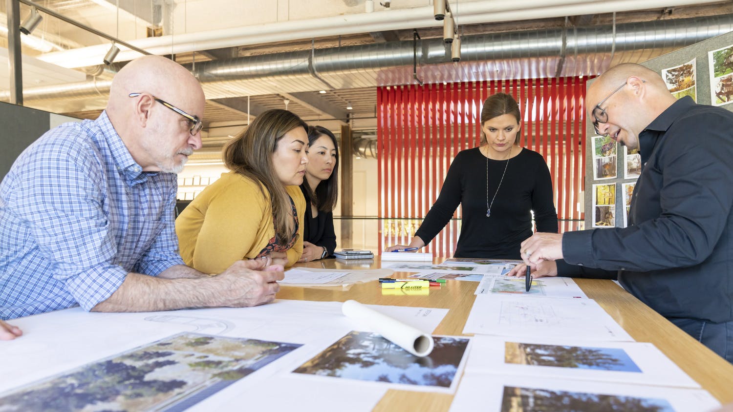 LPA Design Studios team looking over photos and renderings