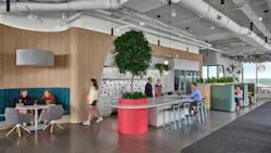 Northeastern University employee dining area shows exposed ceiling infrastructure, gray toned flooring, and natural wood-look accents Northeastern University employee dining area shows exposed ceiling infrastructure, gray toned flooring, and natural wood-look accents