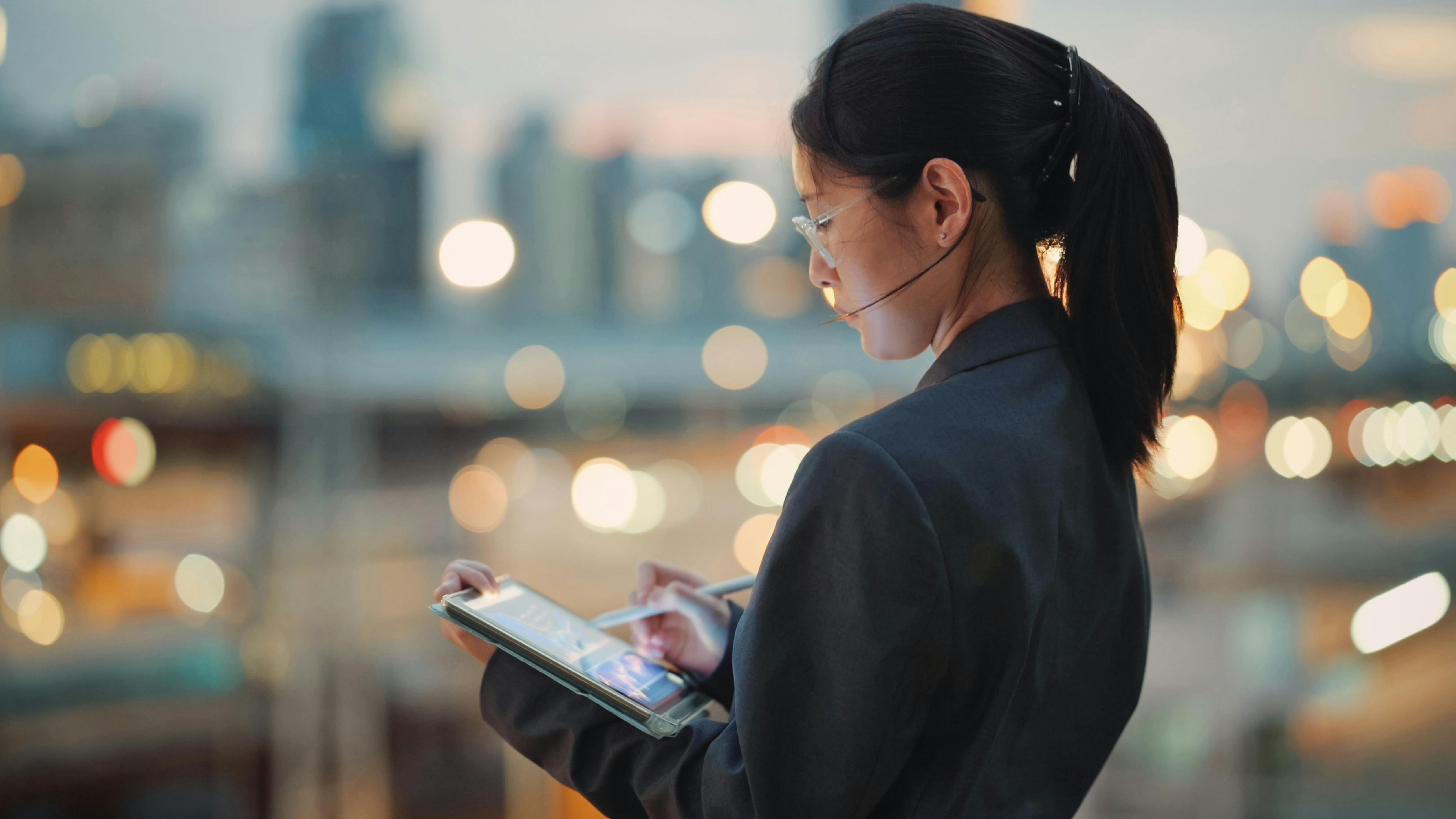 Businesswoman using tablet with artificial intelligence application
