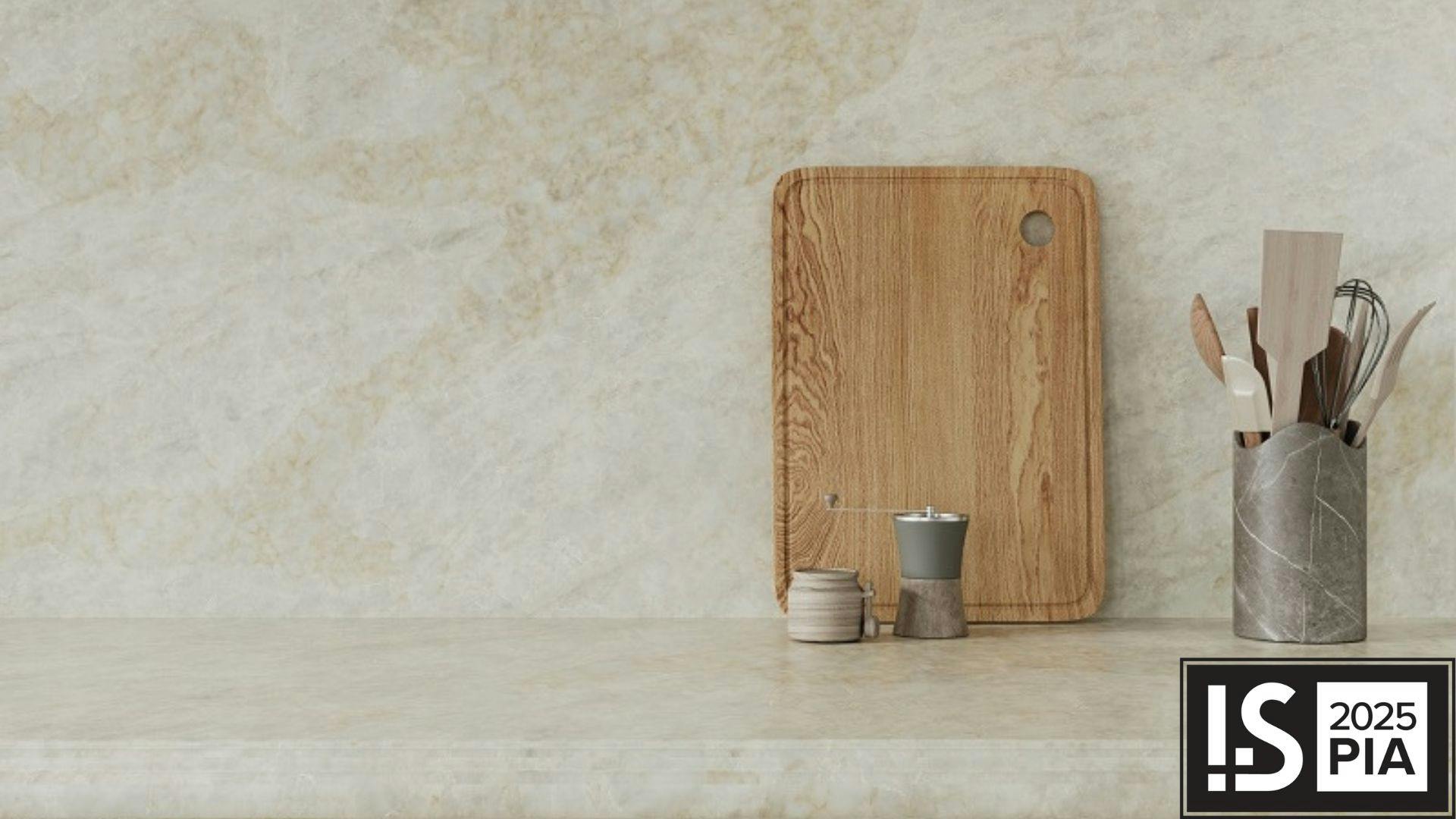 The VIATERA Taj Duna is designed for surfacing applications and features soft veining. Shown as a counter with kitchen utensils set on top.