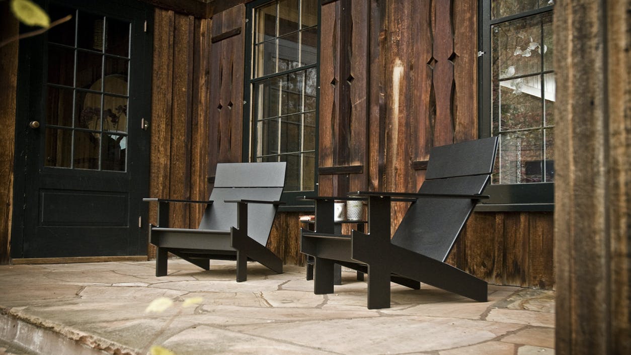 Two Lollygagger Lounge Chairs make a quaint relaxation spot outside a home or business.