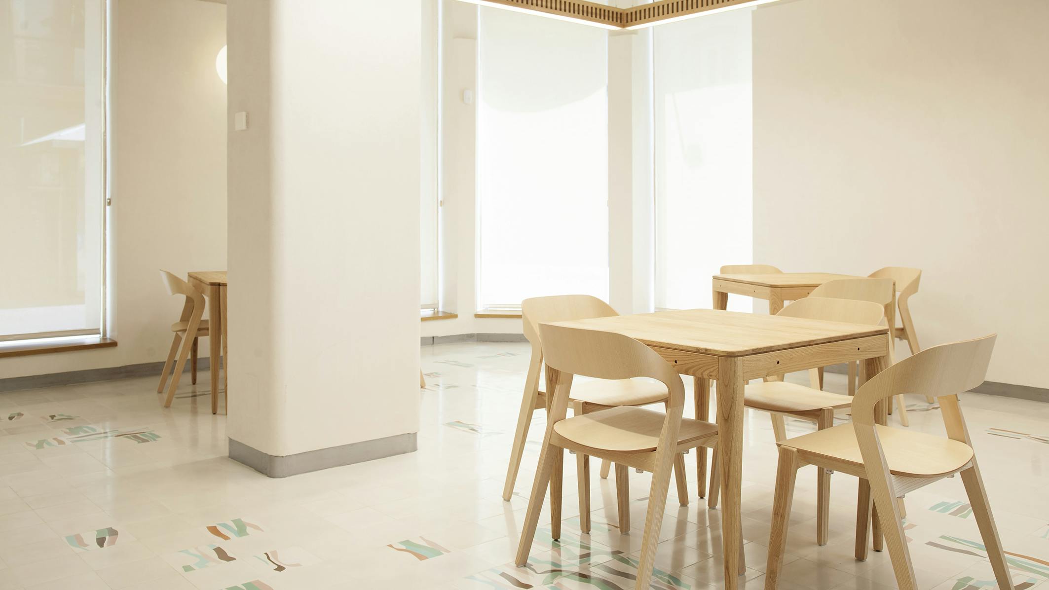 Hightower's Mixis Chair arranged around tables.