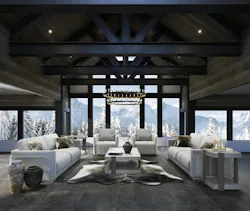 Elegant showroom features heavy timber framing and black steel trusses that are softened through placement of furnishings and accessories in winter whites, against a view of the mountains. Elegant showroom features heavy timber framing and black steel trusses that are softened through placement of furnishings and accessories in winter whites, against a view of the mountains.