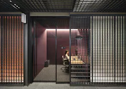 Worker in glass-walled office that shows the continuity of Dreamwall displays in the corridor Worker in glass-walled office that shows the continuity of Dreamwall displays in the corridor