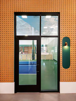 Entrance to pickleball court features pegboard paneling. Entrance to pickleball court features pegboard paneling.