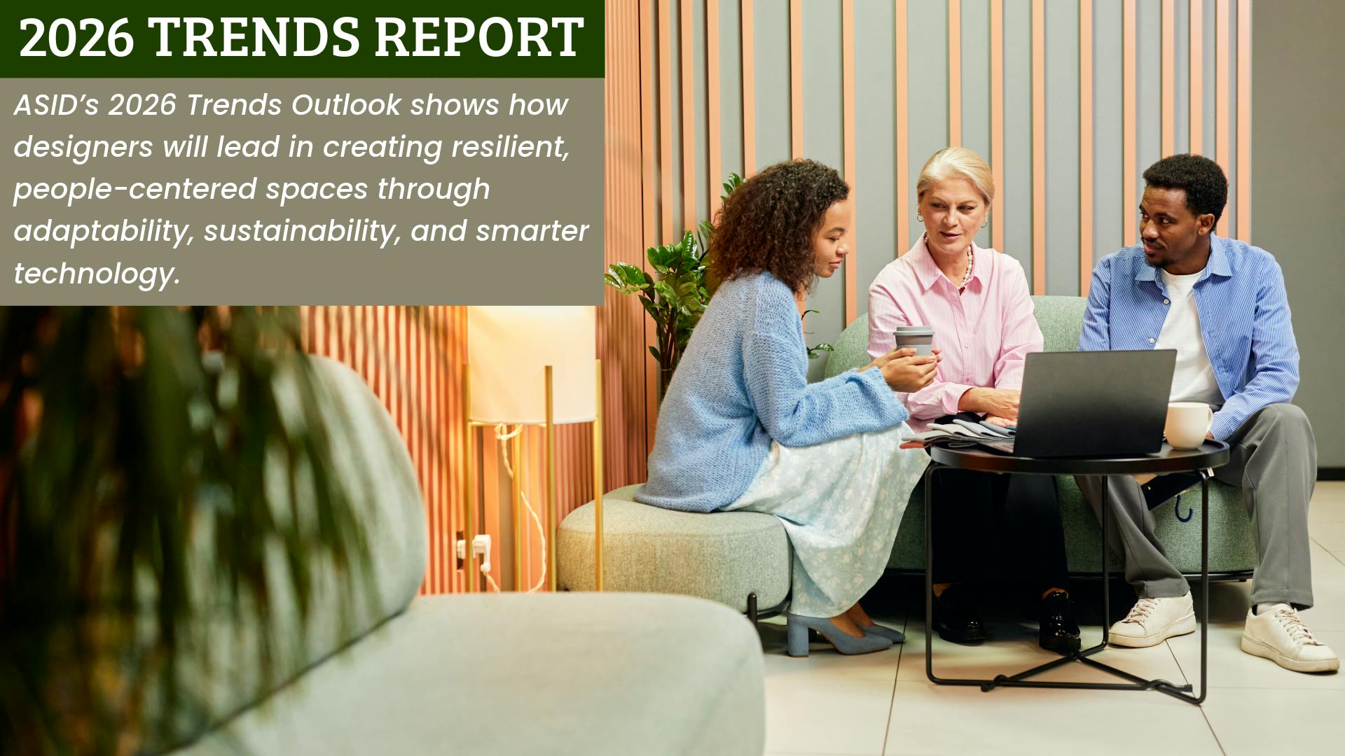 Young Black female and male colleagues sit with an older white female colleague in an informal co-working space