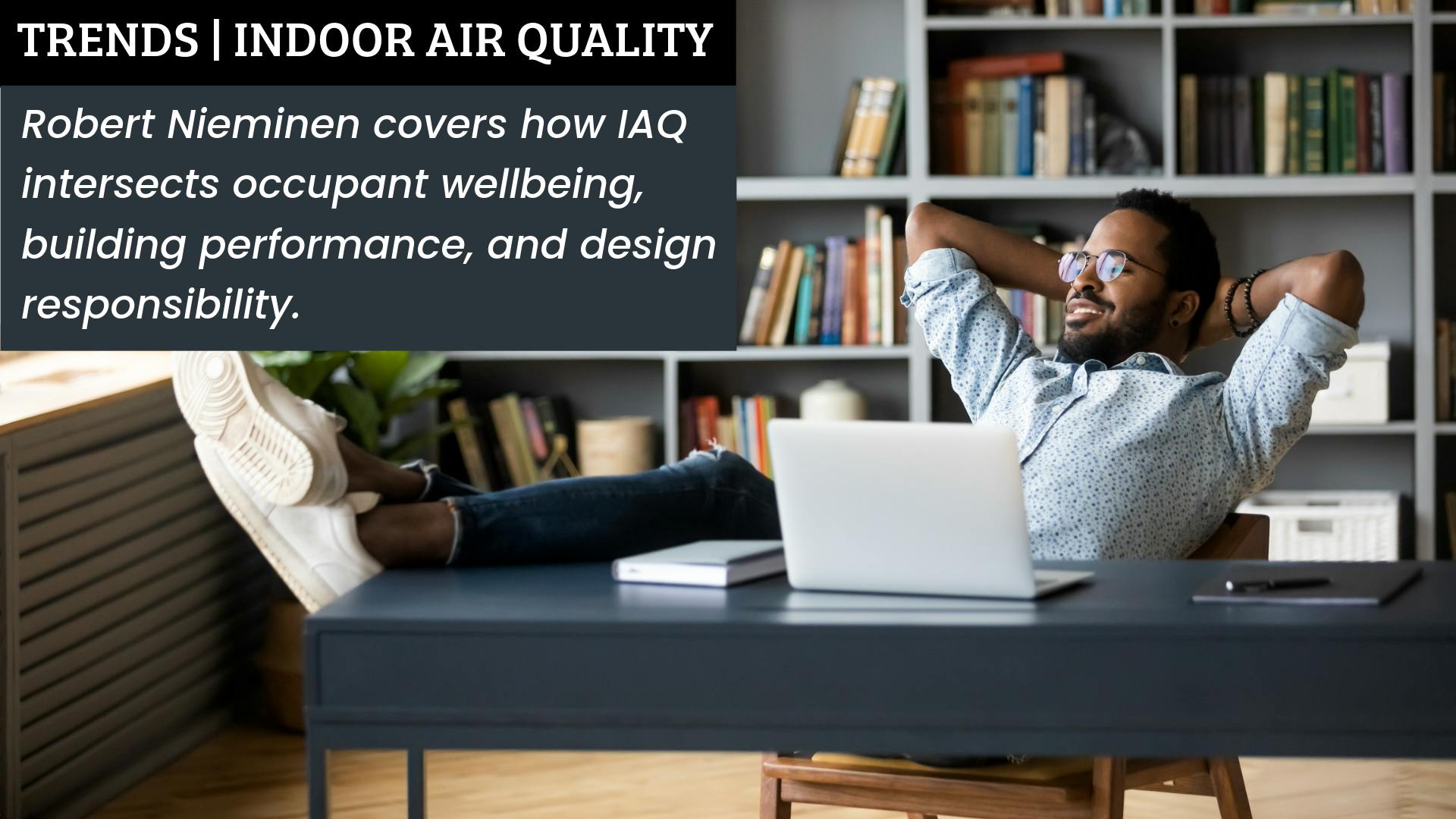 Black male employee enjoys a window view from comfortable office