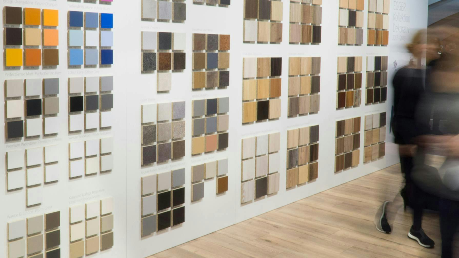 Multi-colored and textured laminate samples mounted on wall for trade show exhibit.