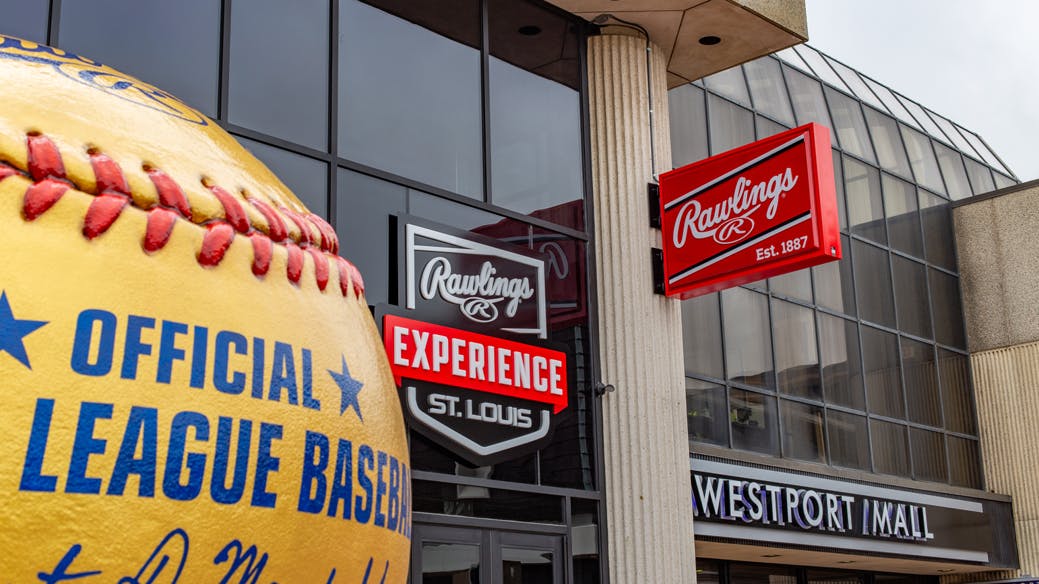 Exterior of the Rawlings Experience Center with brand signage and large baseball sculpture