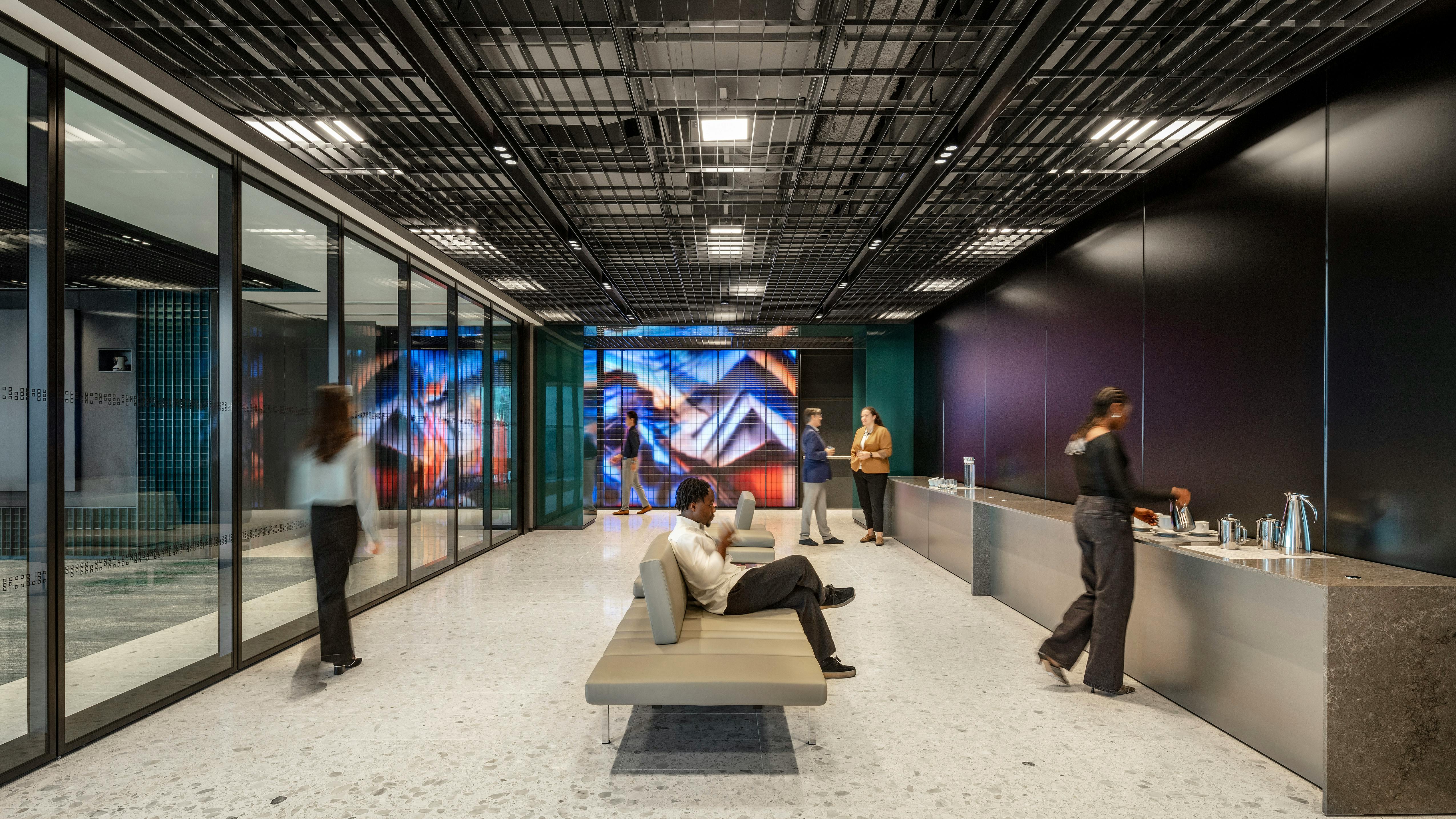 Vibrant interactive digital display surrounds a corporate workplace interior