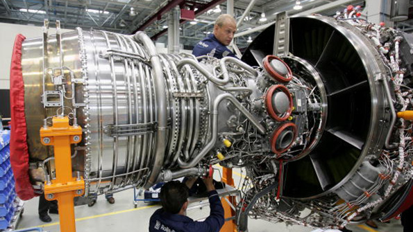 RollsRoyce workers assemble an aircraft jet engine in a Berlin factory