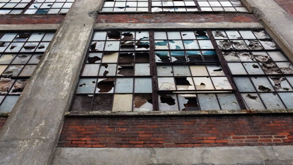 Broken windows in an abandoned factory