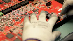 biamp systems employee places connectors on a Nexia board biamp systems employee places connectors on a Nexia board