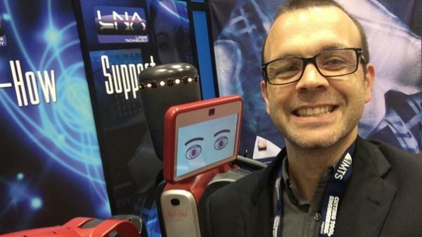 IndustryWeek Technology Editor Travis Hessman gets a hug from his robot buddy