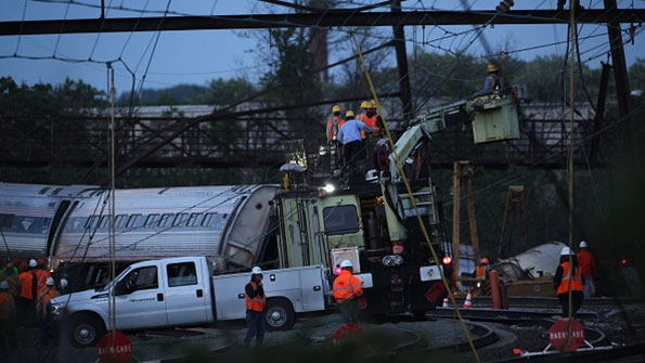 Repair crews inspect damages at the site of yesterdays Philadelphia derailment
