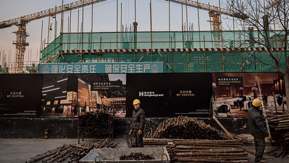 Workers at a site in Beijing