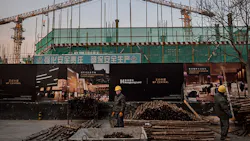Workers at a site in Beijing Workers at a site in Beijing