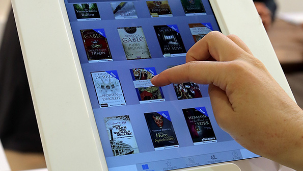 An Apple customer browses ebooks on an iPad