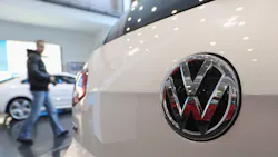 A man walks through a Volkswagen dealership A man walks through a Volkswagen dealership