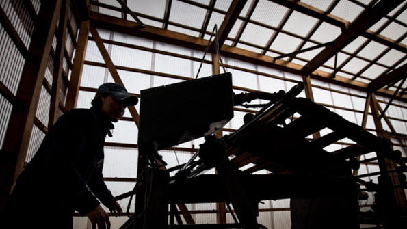 A worker at a weaving machine in a Kojima district factory