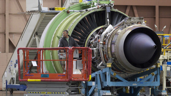 A Boeing employee checks out a GE Avition engine for a 777