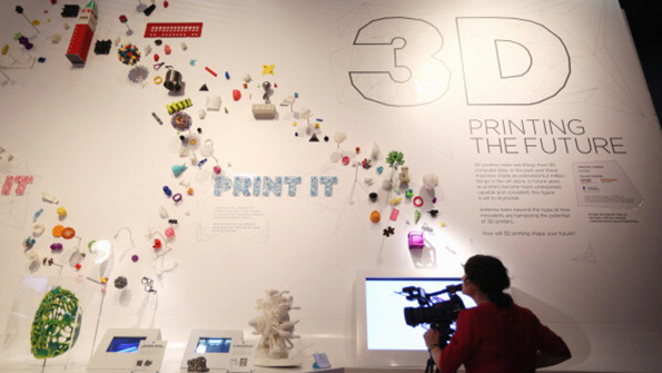 A woman films a 3D printing museum display
