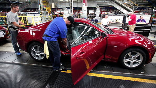 GM workers polish off another 2016 Chevy Camaro at the Lansing Mich plant