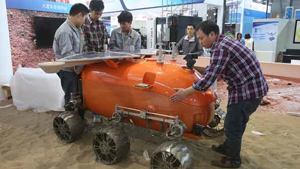 Technicians in Shanghai install a selfdeveloped prototype airplane designed for probing Mars at the China International Industry Fair