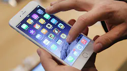 A customer tries out an Apple iPhone 6 A customer tries out an Apple iPhone 6