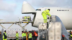 Airport workers load cargo through the nose of a Boeing 747 Airport workers load cargo through the nose of a Boeing 747