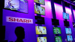 A CES attendee looks at the wall of screens in the Sharp booth A CES attendee looks at the wall of screens in the Sharp booth