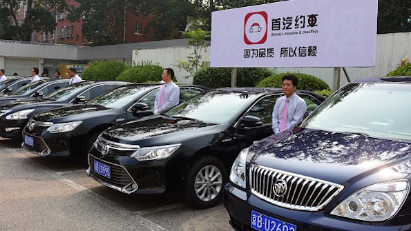Chauffeurs in China await bookings on the ridesharing app Didi