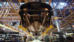 The underbelly of a car at an auto factory The underbelly of a car at an auto factory