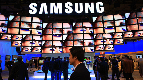 A wall of Samsung television screens at a tech expo booth