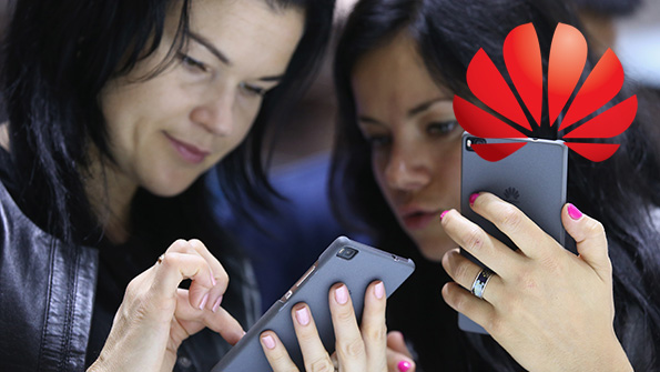 Two show attendees test the Huawei Honor 7 at the 2015 IFA