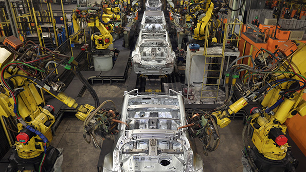 Industrial robots work on cars at a Nissan plant