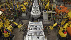 Industrial robots work on cars at a Nissan plant Industrial robots work on cars at a Nissan plant